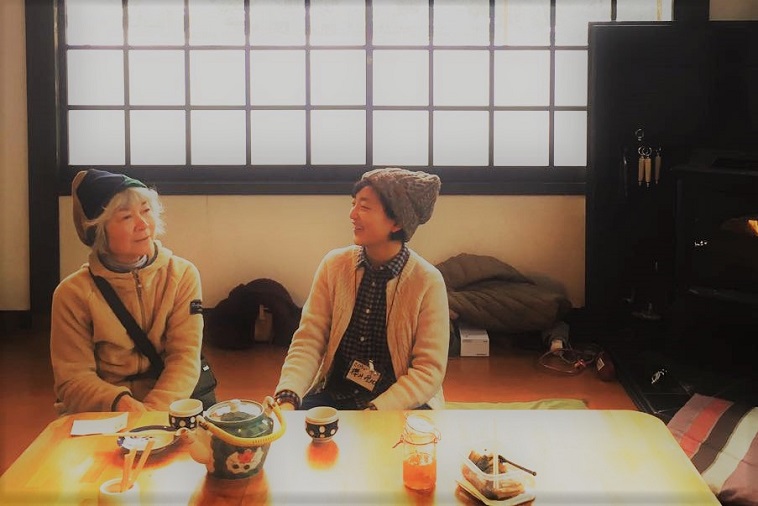 【写真】おばあさんとお話しする暮らしの保健室のスタッフ。穏やかな雰囲気が流れている。