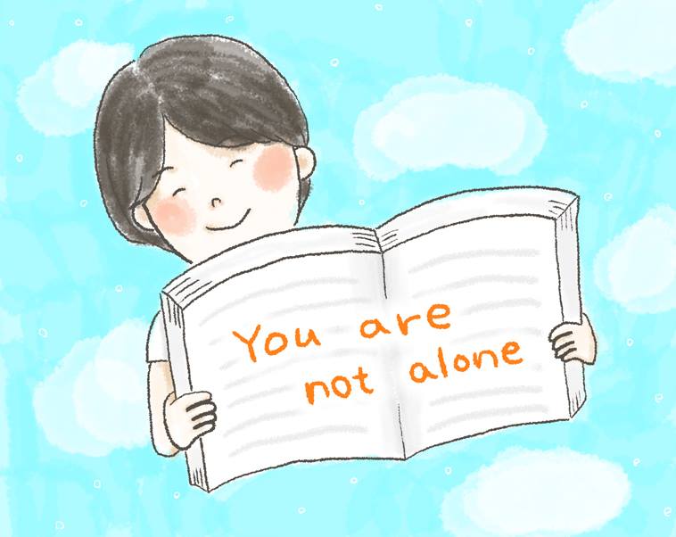 【イラスト】「You are not alone」と書いたノートを開いて見せる、さかいさん