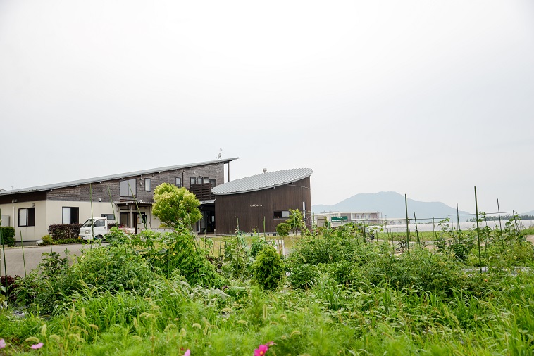 【写真】畑があり、その奥に住宅がある「子どもの村福岡」の様子。