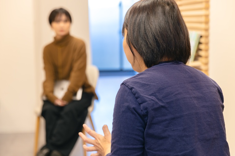 【写真】インタビューにこたえるたなかせんせいの後ろ姿